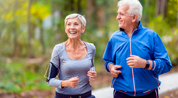 Senior active couple running, walking and talking in the park. Healthy lifestyle